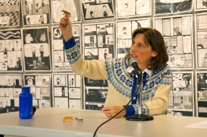 Kristy Athens holds up a tiny cow. 
